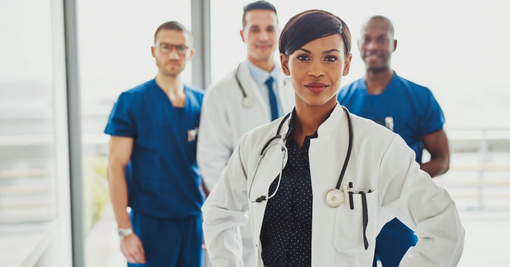 doctors standing proudly to illustrate what a doctor does